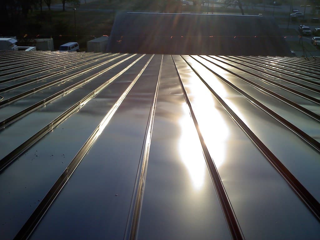 Close-up of a freshly finished standing seam metal roof catching the light